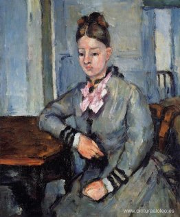 Madame Cézanne apoyada en una mesa