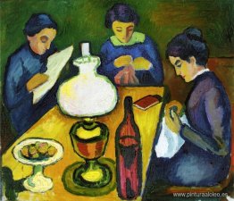 Tres mujeres en la mesa junto a la lámpara.